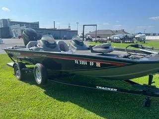 Slide: The Image of 2016 Tracker Pro Team 195 TXW boat on trailer, parked on grass under clear sky. - 9