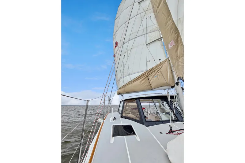 Slide: The Image of 2018 Maine Cat 38 LS sailing on open water under clear blue skies. - 16