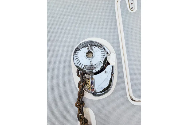 Slide: The Image of Anchor windlass on 2018 Maine Cat 38 LS, featuring a metal chain and polished finish. - 25