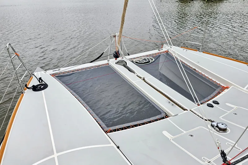 Slide: The Image of 2018 Maine Cat 38 LS catamaran deck with netting, ropes, and water view. - 27