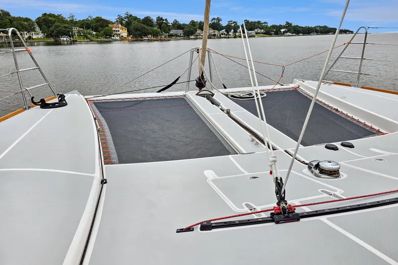 Slide: The Image of 2018 Maine Cat 38 LS catamaran deck with netting, moored on a calm river. - 28