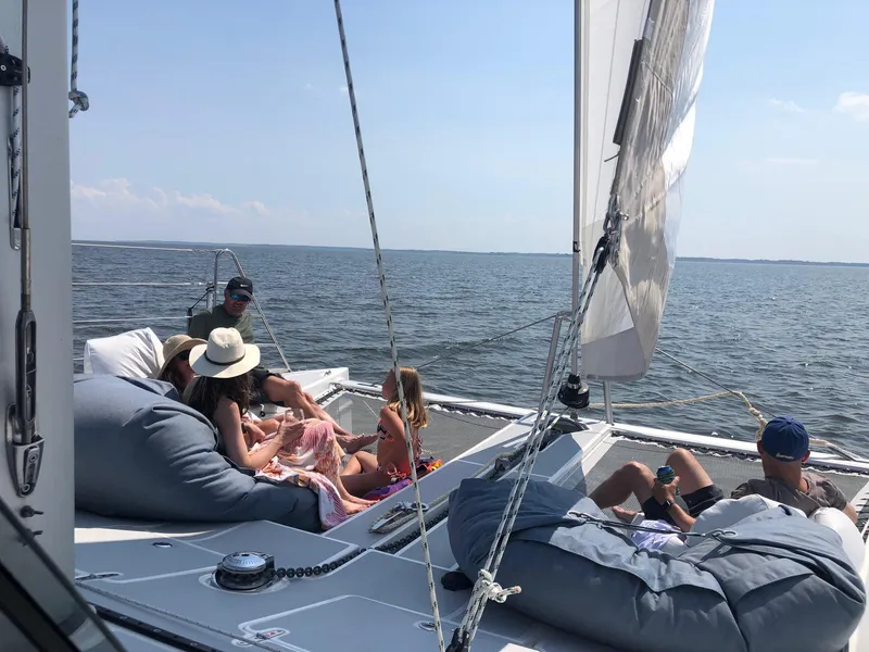 Slide: The Image of People relaxing on a 2018 Maine Cat 38 LS sailboat, enjoying a sunny day at sea. - 30