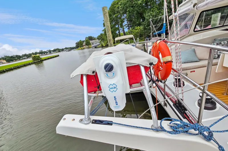 Slide: The Image of 2018 Maine Cat 38 LS docked, featuring safety equipment and scenic waterfront view. - 38