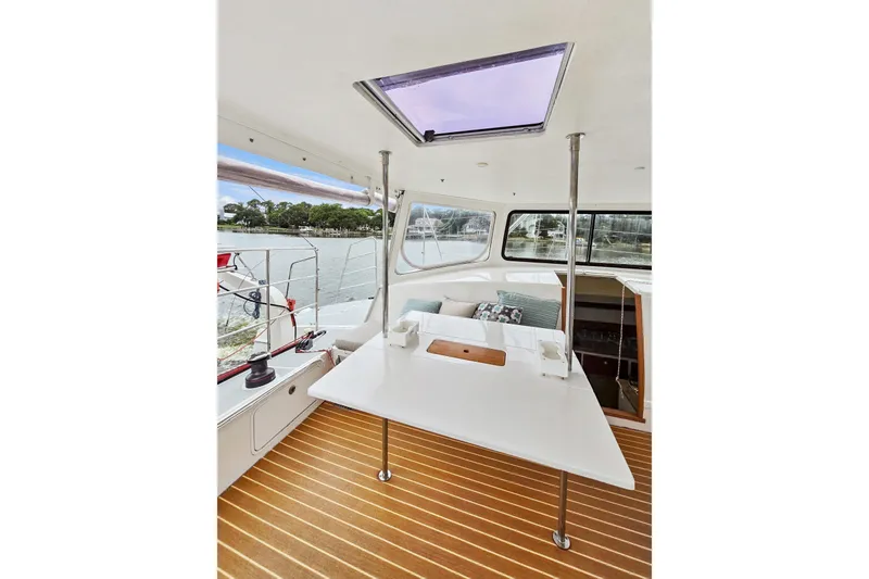 Slide: The Image of 2018 Maine Cat 38 LS interior with table, windows, and scenic water view. - 45