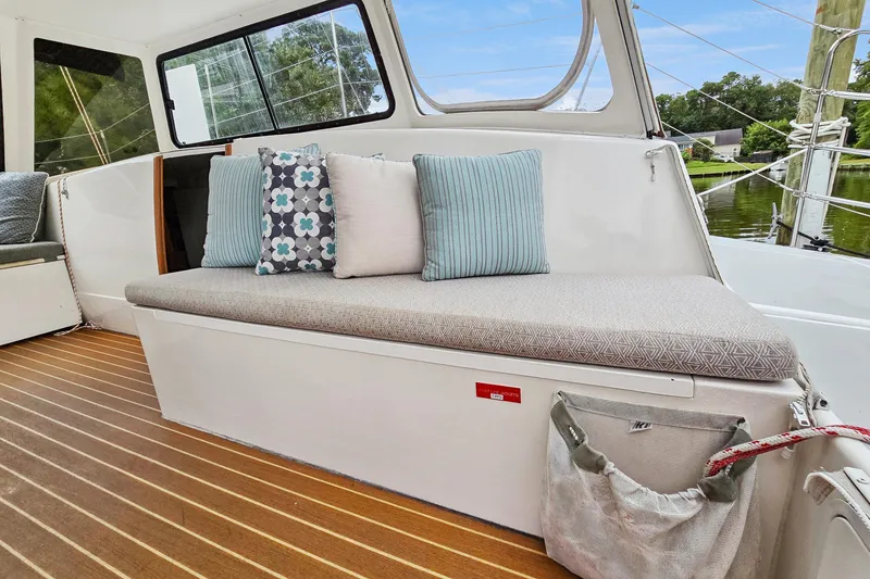 Slide: The Image of 2018 Maine Cat 38 LS interior with cushioned seating and decorative pillows. - 48