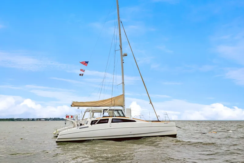 Slide: The Image of 2018 Maine Cat 38 LS sailing on open water under a clear blue sky. - 5