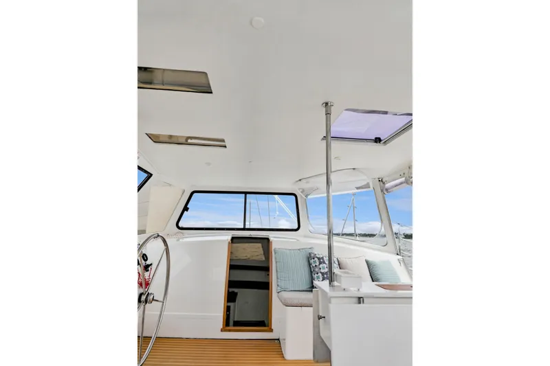 Slide: The Image of Interior of 2018 Maine Cat 38 LS, featuring helm, seating, and panoramic windows. - 51
