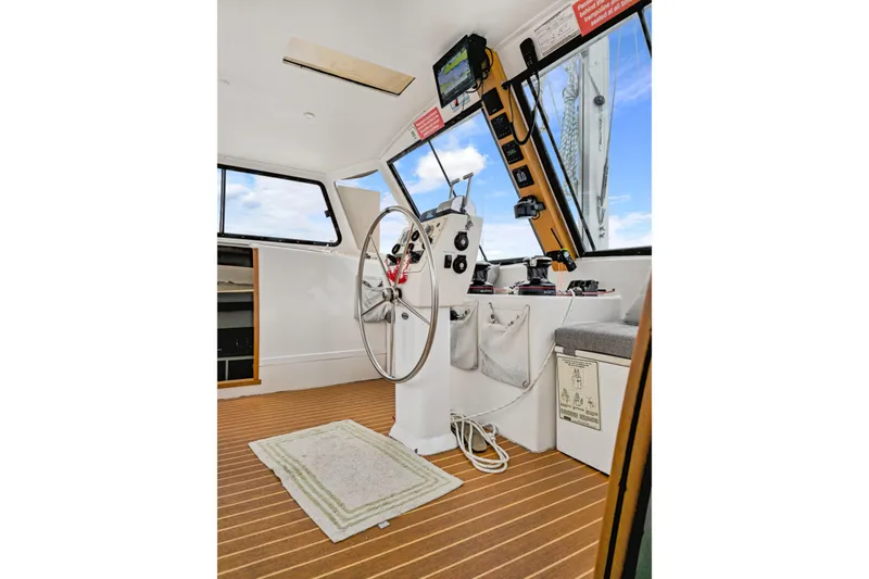 Slide: The Image of Interior helm of 2018 Maine Cat 38 LS with steering wheel and navigation equipment. - 53