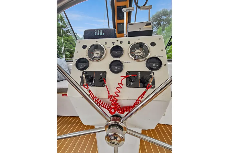 Slide: The Image of Helm of 2018 Maine Cat 38 LS with gauges and controls, featuring a JBL speaker. - 54