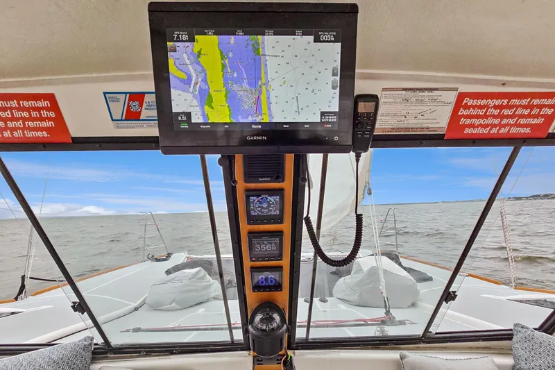 Slide: The Image of Cockpit view of 2018 Maine Cat 38 LS with navigation display and ocean scenery. - 56