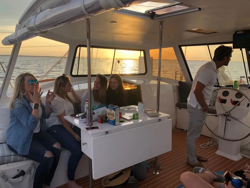 Slide: The Image of Group enjoying sunset on 2018 Maine Cat 38 LS yacht, with snacks and drinks. - 58