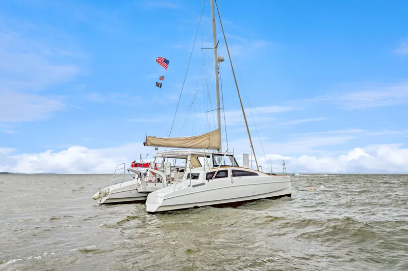 Slide: The Image of 2018 Maine Cat 38 LS catamaran sailing on open water under a clear blue sky. - 6