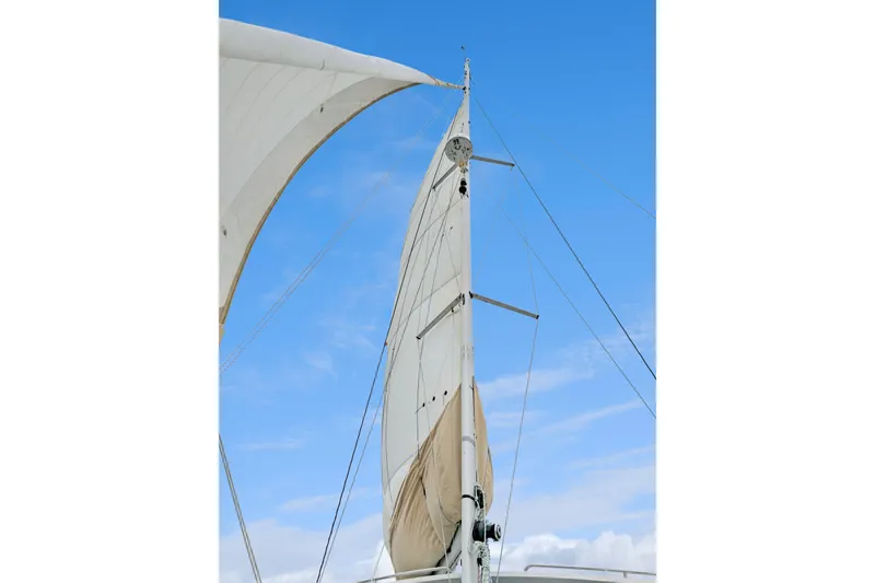 Slide: The Image of Sails of a 2018 Maine Cat 38 LS against a clear blue sky. - 60