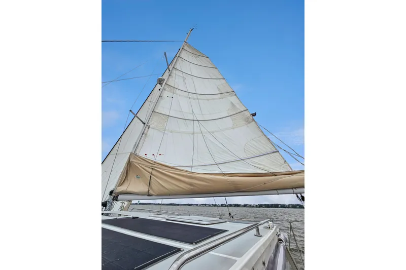Slide: The Image of Sailing on a 2018 Maine Cat 38 LS with full sails against a clear blue sky. - 61