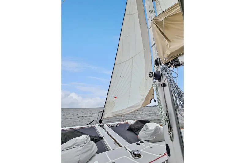 Slide: The Image of Sailing on a 2018 Maine Cat 38 LS catamaran with white sails against a blue sky. - 62