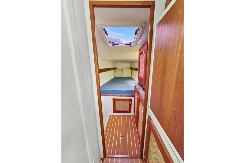 Slide: The Image of Cozy cabin interior of 2018 Maine Cat 38 LS with wooden accents and skylight. - 64