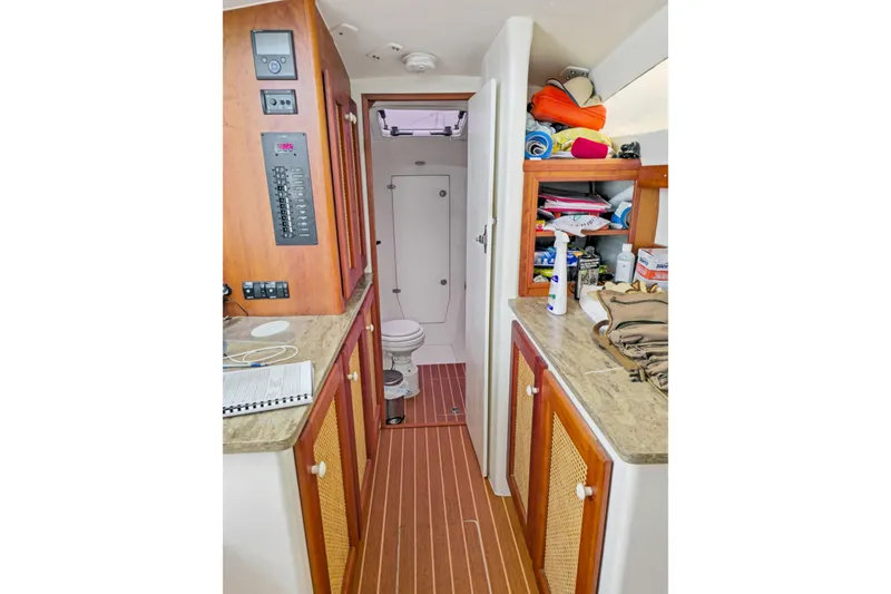 Slide: The Image of 2018 Maine Cat 38 LS interior with wooden cabinetry and compact bathroom. - 68