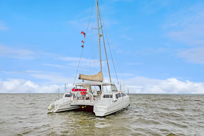 Slide: The Image of 2018 Maine Cat 38 LS catamaran sailing on open water under a clear blue sky. - 7