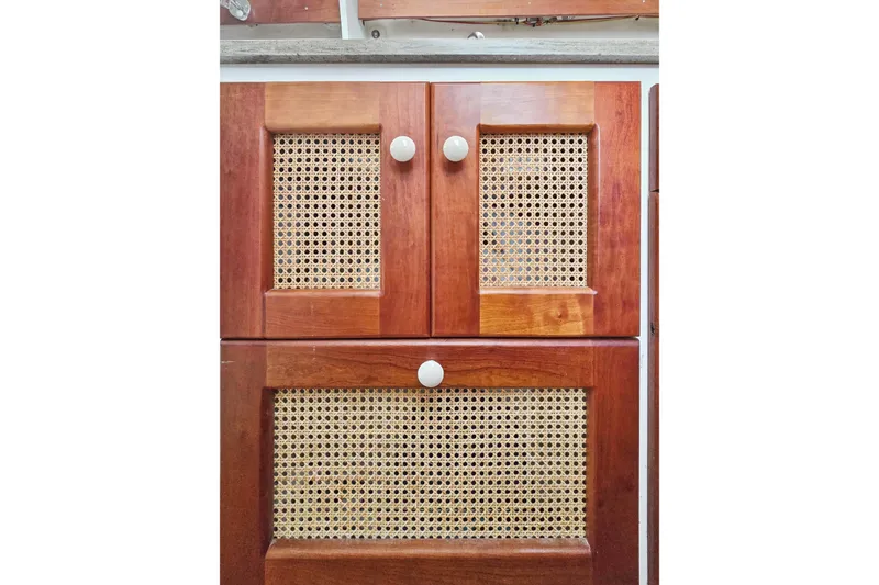 Slide: The Image of Wooden cabinet doors with woven cane panels on a 2018 Maine Cat 38 LS. - 70