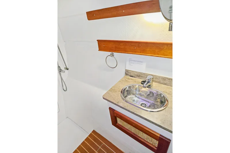 Slide: The Image of Bathroom sink area in 2018 Maine Cat 38 LS yacht, featuring wooden accents and modern fixtures. - 73