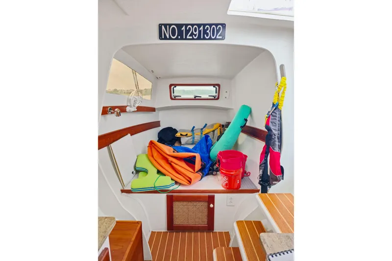 Slide: The Image of Interior of 2018 Maine Cat 38 LS with colorful gear and wooden flooring. - 75