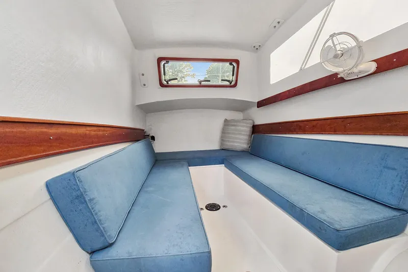 Slide: The Image of Interior of 2018 Maine Cat 38 LS with blue seating and wooden accents. - 76