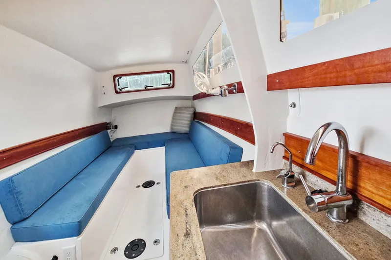 Slide: The Image of Interior of 2018 Maine Cat 38 LS with blue seating and kitchenette. - 78