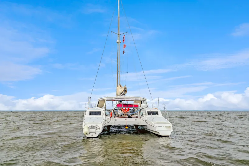 Slide: The Image of 2018 Maine Cat 38 LS catamaran sailing on open water under a clear blue sky. - 8