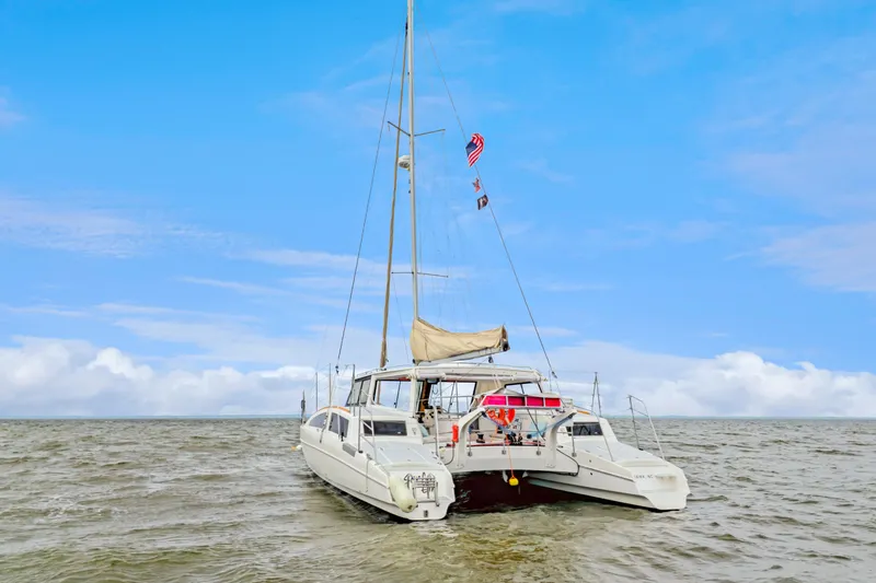 Slide: The Image of 2018 Maine Cat 38 LS catamaran sailing on open water under a clear blue sky. - 9