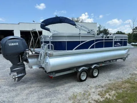 Slide: The Image of 2024 Bennington 22SVSR pontoon boat with Yamaha motor on a trailer, parked outdoors. - 3