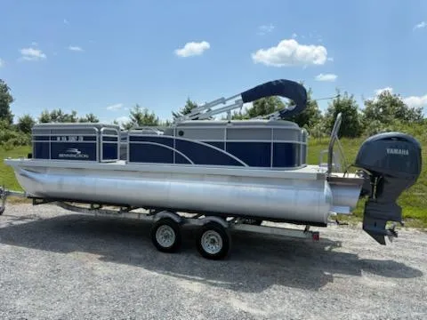Slide: The Image of 2024 Bennington 22SVSR pontoon boat with Yamaha motor on a trailer, parked outdoors. - 4