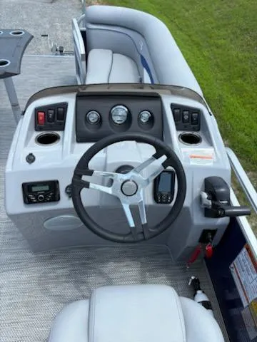 Slide: The Image of 2024 Bennington 22SVSR boat dashboard with steering wheel, gauges, and controls. - 9