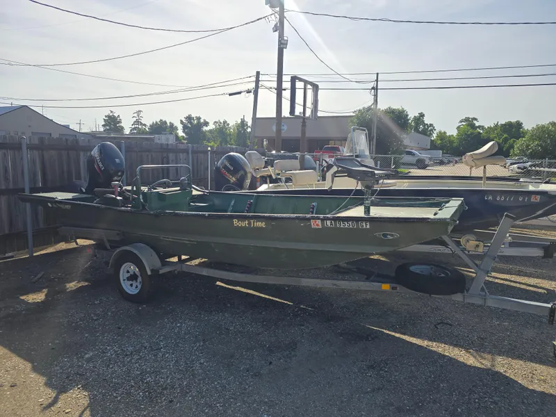 Slide: The Image of Custom Flat 16 boat on trailer, parked outdoors, with visible outboard motors. - 1