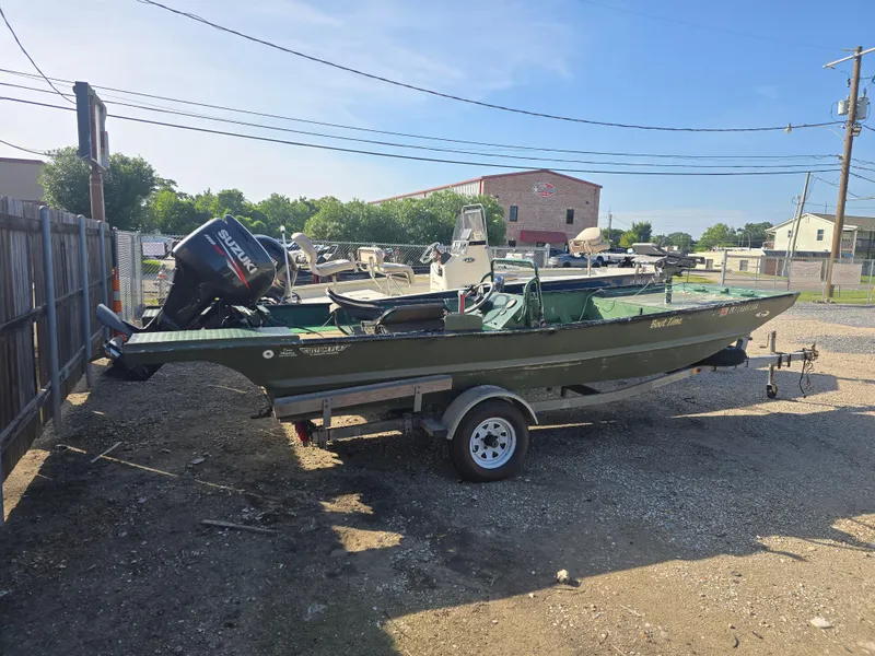 Slide: The Image of Custom Flat 16 boat from 2016 on trailer, equipped with Suzuki outboard motor. - 3