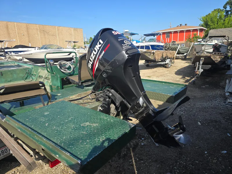 Slide: The Image of Boat with Suzuki outboard motor in a marina, Custom Flat 16 model, 2016. - 7