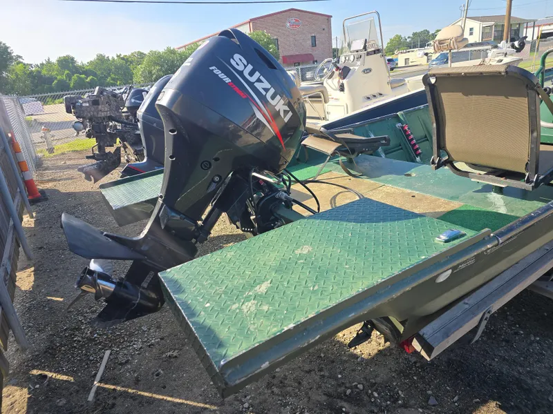 Slide: The Image of Boat with Suzuki outboard motor, Custom Flat 16 model, 2016, parked outdoors. - 8