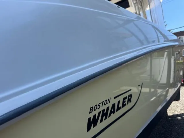 Slide: The Image of 2004 Boston Whaler 320 Outrage boat side view with logo. - 2