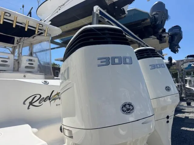 Slide: The Image of 2004 Boston Whaler 320 Outrage with twin 300 horsepower engines, docked in a marina. - 4