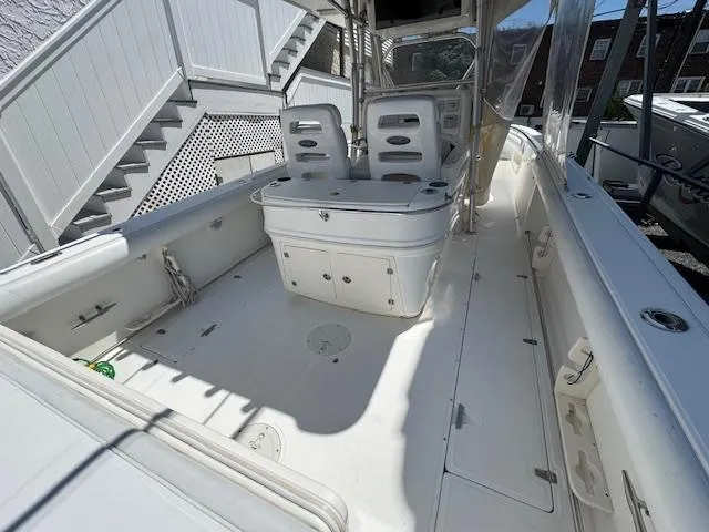 Slide: The Image of 2004 Boston Whaler 320 Outrage boat interior with seating and storage compartments. - 8
