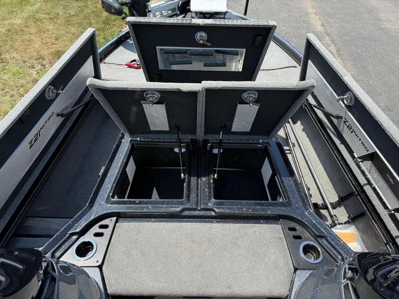 Slide: The Image of 2019 Nitro Z21 boat interior with open storage compartments and fishing rod holders. - 13