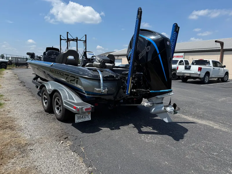 Slide: The Image of 2019 Nitro Z21 boat on trailer, parked in lot under blue sky. - 3