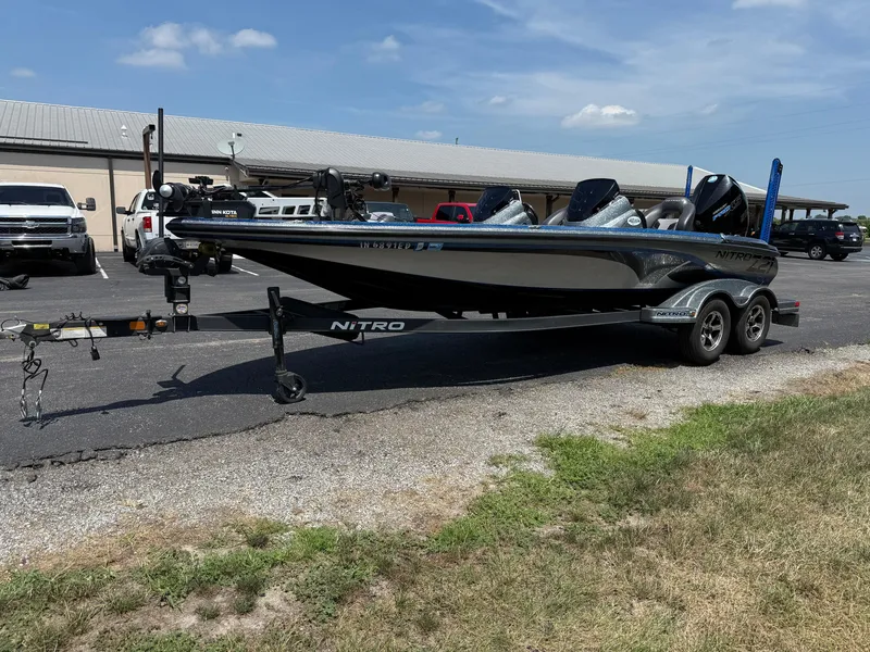 Slide: The Image of 2019 Nitro Z21 boat on trailer in parking lot, sunny day. - 5