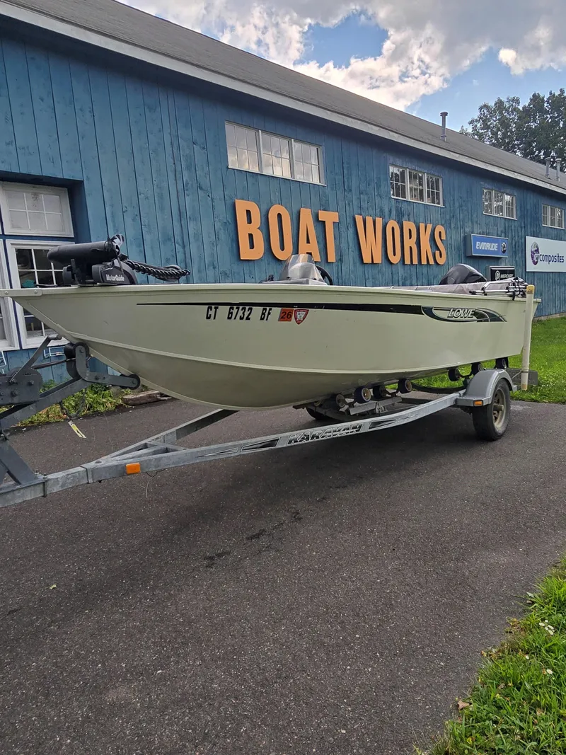 Slide: The Image of 2012 Lowe AN160S boat on trailer outside "Boat Works" building. - 1