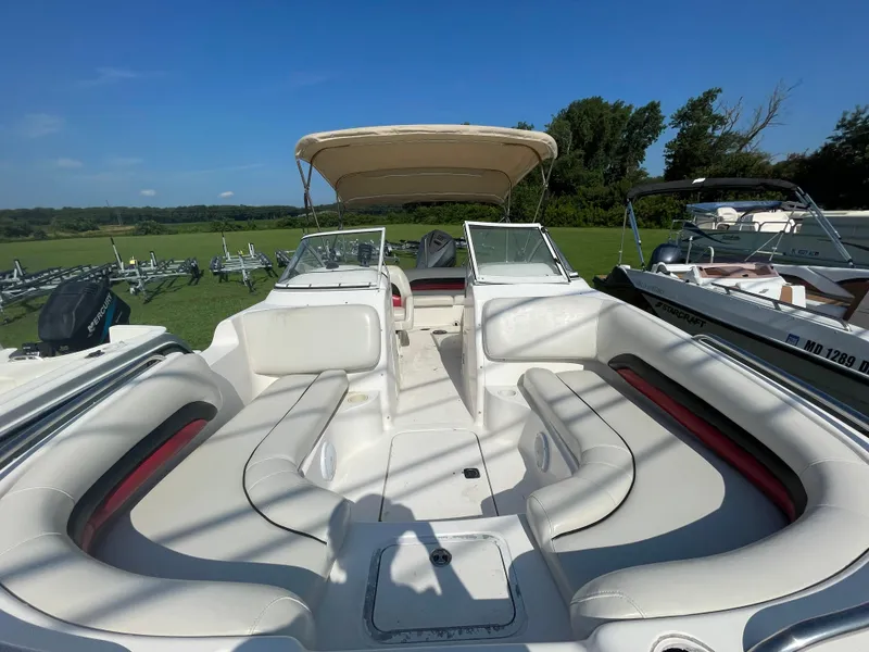 The Image of 2004 Hurricane 217 OB boat with spacious seating and canopy, parked on grass. - 1
