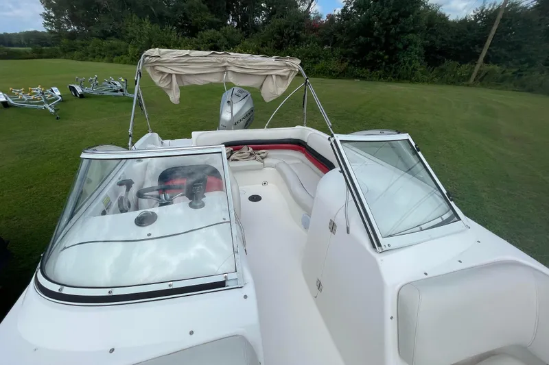 Slide: The Image of 2004 Hurricane 217 OB boat with canopy on grassy field. - 20