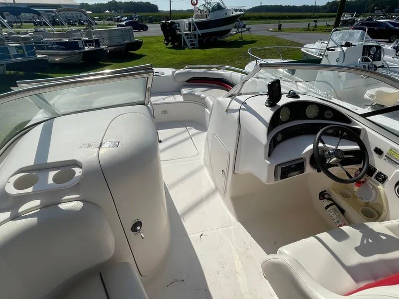 Slide: The Image of 2004 Hurricane 217 OB boat interior with steering wheel, dashboard, and seating area. - 3