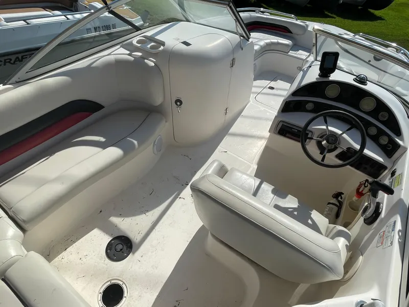 Slide: The Image of 2004 Hurricane 217 OB boat interior with white seating and steering console. - 7