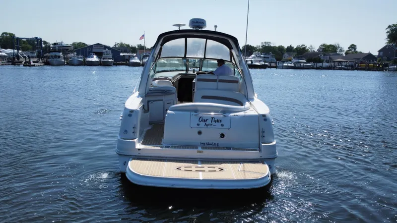 Slide: The Image of 2004 Sea Ray 320 Sundancer cruising on a sunny day in a marina. - 10
