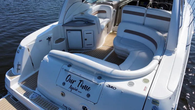 Slide: The Image of 2004 Sea Ray 320 Sundancer boat with spacious seating on calm water. - 12