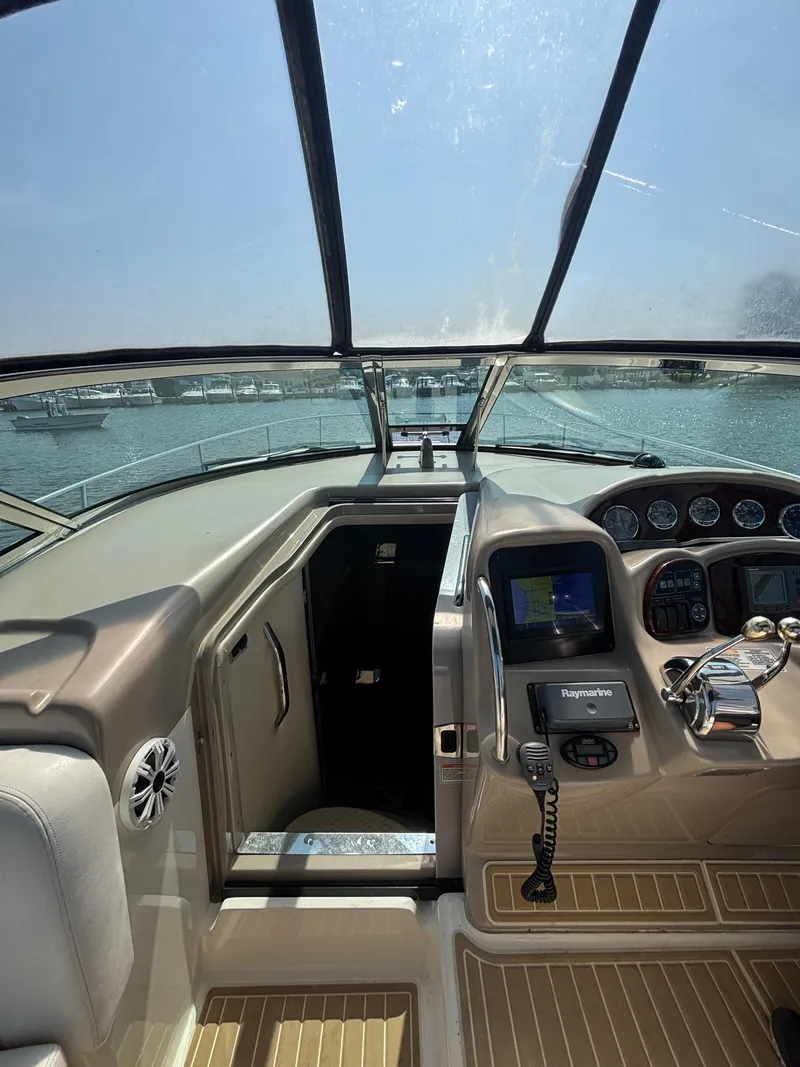 Slide: The Image of Cockpit view of 2004 Sea Ray 320 Sundancer with navigation equipment and open cabin door. - 16